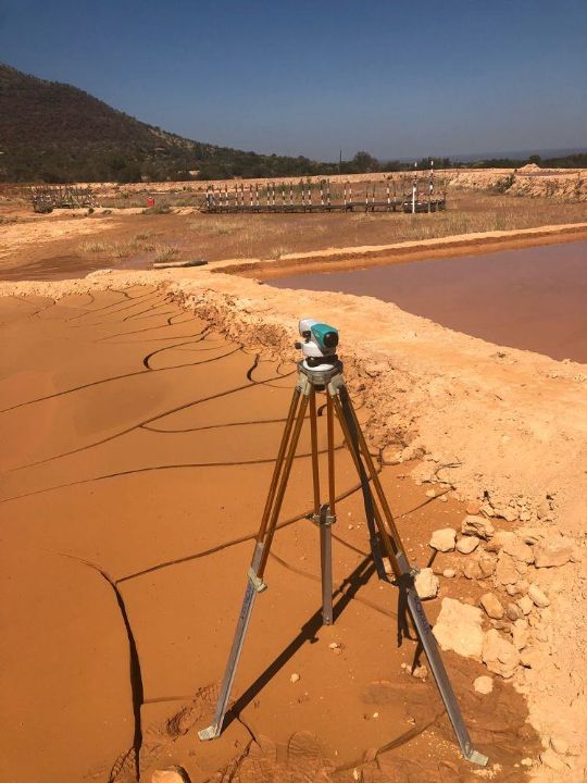 Survey level set up on a tailings dam wall